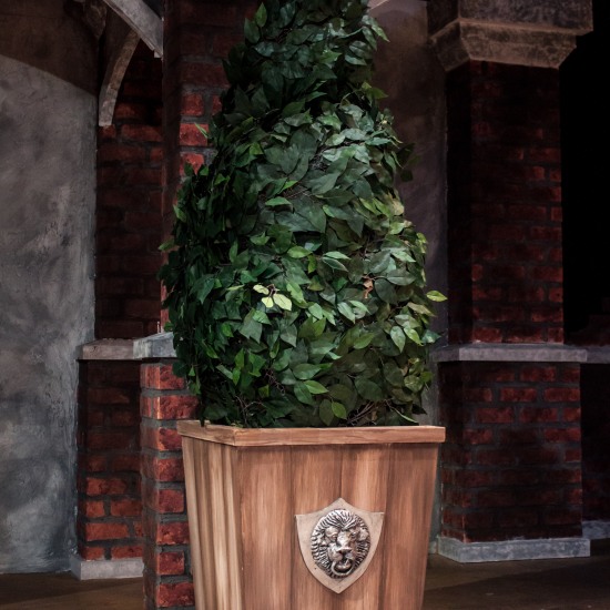 Painted topiary base and lion head emblem